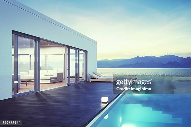 modern luxury house with pool at dawn - villa pool stockfoto's en -beelden