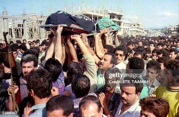 Lebanon: Palestinian members of the Islamic Jihad carry the body of their comrade Marouan Abedi Aal during his funeral 28 October 1992 in Tripoli,...