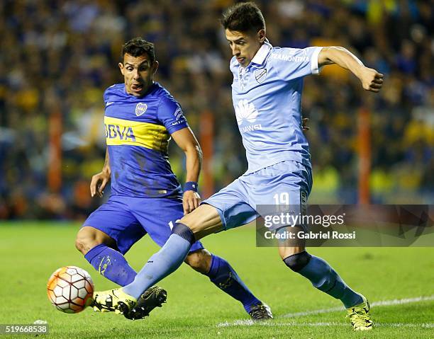 Nelson Cabrera of Bolivar fights for the ball with Carlos Tevez of Boca Juniors during a match between Boca Juniors and Bolivar as part of Group 3 of...