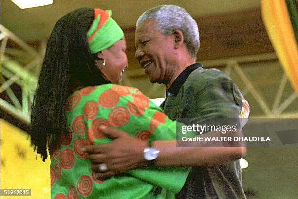 South African President Nelson Mandela congratulates his wife Winnie after she has been elected to the National Executive Committee of the African...