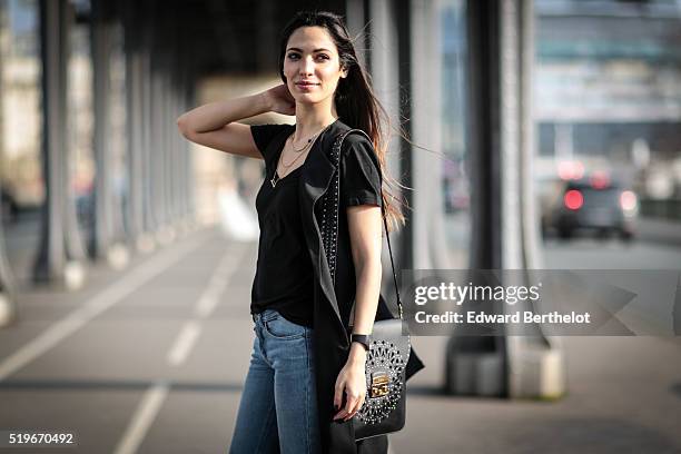 Sofya Benzakour , is wearing a New look black jacket, a New Look black top, Berenice blue jeans, Primark black boots, and a Furla black bag, during a...