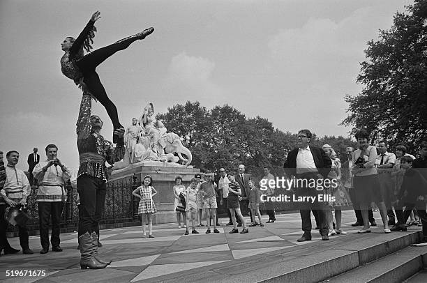 Dancers from the Bolshoi Theatre, Nicholai Trubsky and Julia Romanenko, entertain the crowds by the Albert Memorial in Kensington Gardens, London,...