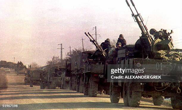 Column of Russian troops, with armor and anti-aircraft cannons, heads toward the Chechnyan capital 0f Grozny 11 December 1994. The convoy was...