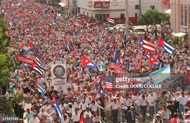 Tens of thousands of people, mostly Cubans living in the US, march through the streets of the Little Havana section of Miami, Florida,10 December...