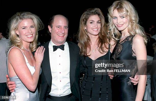 Revlon Chairman Ronald Perelman poses with supermodels Vendela , Cindy Crawford and Claudia Schiffer at the Fire and Ice Ball 07 December 1994 in Los...