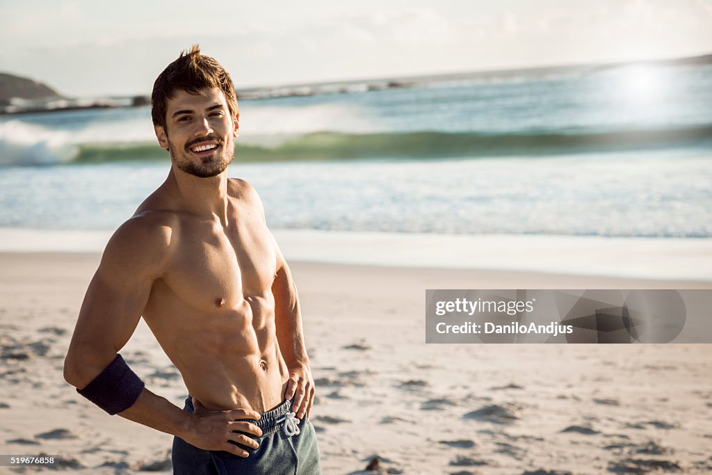 Smiling fit man relaxing after workout