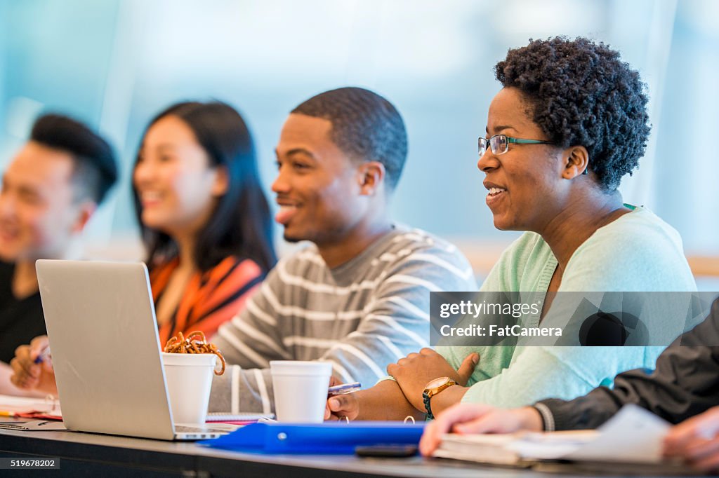 A multi-ethnic group of college students are sitting