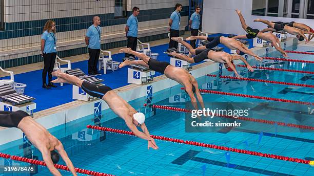 male swimmer jumping - swimming competition stock pictures, royalty-free photos & images