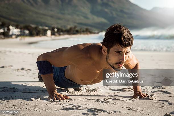 s'adapter l'homme faire des poussoir ups sur la plage - men abs beach photos et images de collection