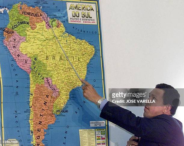 Venezuelan President Hugo Chavez shows a map of South America to explane Venezuelan border problems that he maintains with Guyana during a press...