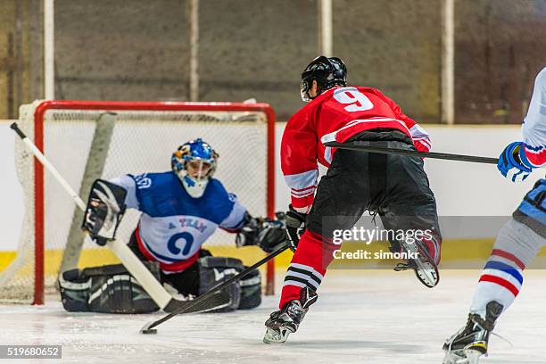 men playing ice hockey - hockey net stock pictures, royalty-free photos & images