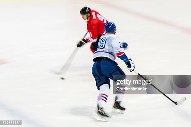men playing ice hockey - professional hockey stock pictures, royalty-free photos & images