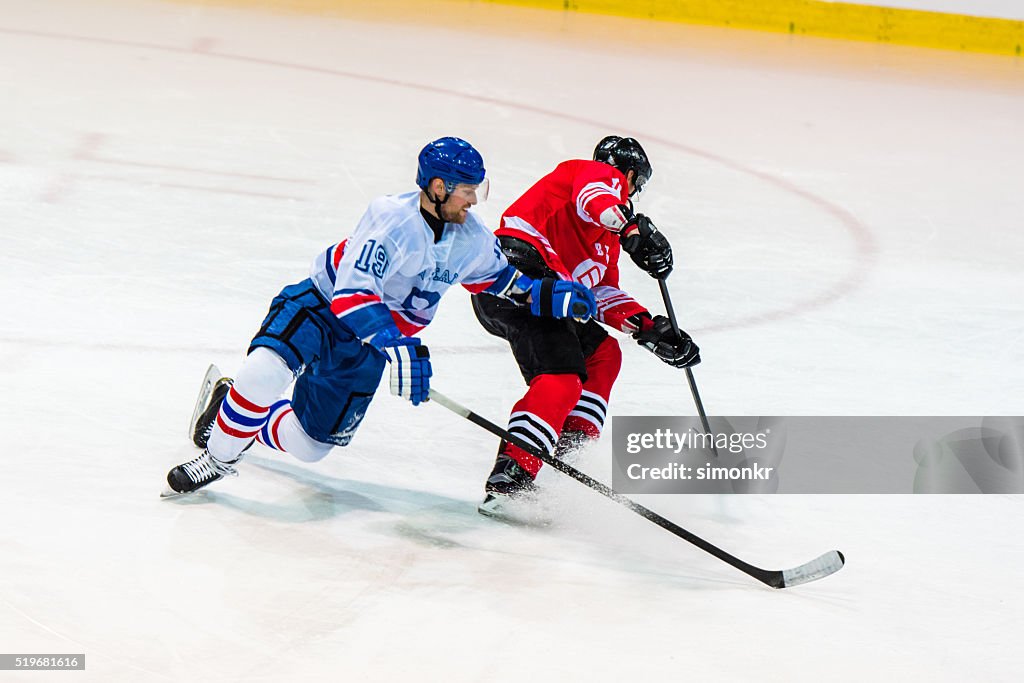 Men playing ice hockey