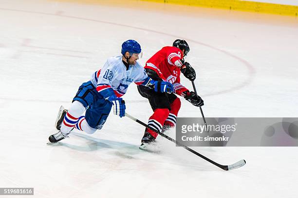 men playing ice hockey - hockey stock pictures, royalty-free photos & images