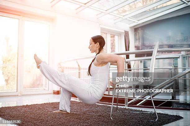 woman in white exercising with a chair - dipping stock pictures, royalty-free photos & images