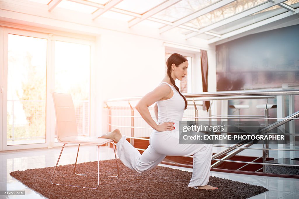 Woman in white exercising lunges
