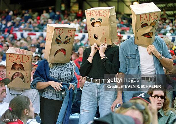 Atlanta Braves' fans wears papers bags which reads "Sad to be Braves fans" during game three of the National League divisional playoffs against the...