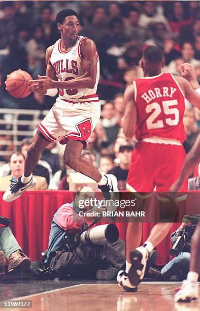 Chicago Bulls forward Scottie Pippen jumps into the air as he recovers a ball knocked loose by Houston Rockets forward Robert Horry in the first half...