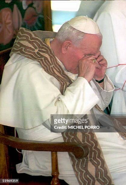 Pope John Paul II rubs his eyes 18 January prior to giving a Mass in Port Moresby before departing on the next leg of his four-nation 11-day Asian...