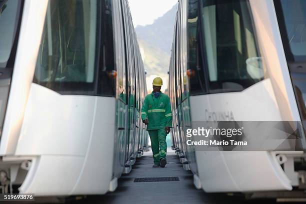 Worker walks between new VLT trains during the testing phase ahead of the upcoming Rio 2016 Olympic Games on April 7, 2016 in Rio de Janeiro, Brazil....