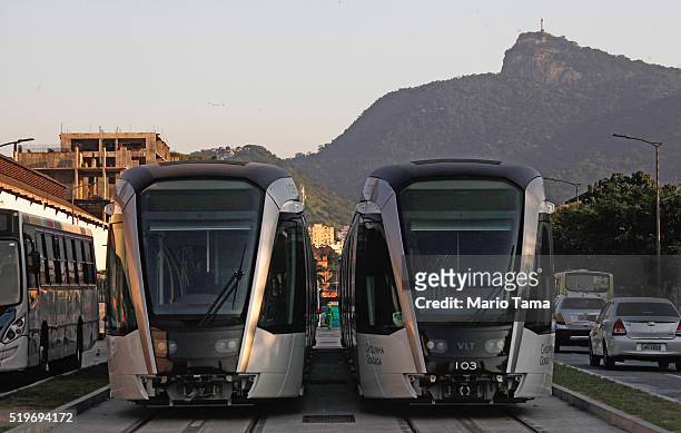 New VLT trains sit on tracks, with Christ the Redeemer statue in the background, during the testing phase ahead of the upcoming Rio 2016 Olympic...