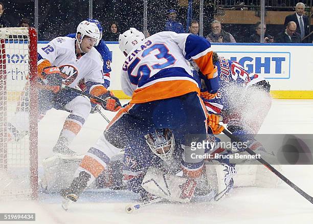 Antti Raanta of the New York Rangers makes the save as Casey Cizikas of the New York Islanders looks for the rebound during the third period at...