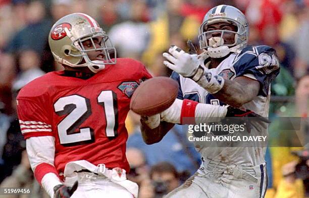 Cornerback Deion Sanders of the San Francisco 49ers breaks up a pass intended for Michael Irvin of the Dallas Cowboys during fourth quarter of their...