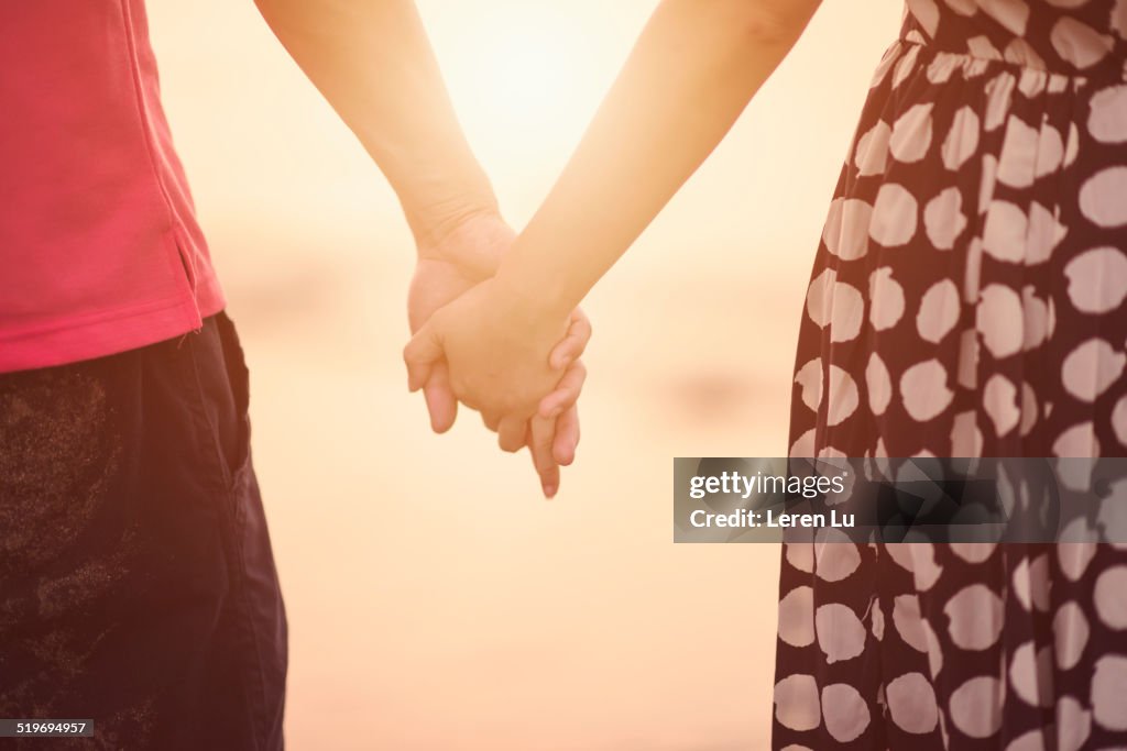 Young couple holding hands.