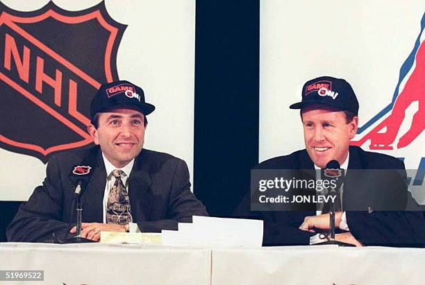 Commissioner Gary Bettman and executive director of the NHL Players Association Bob Goodenow wear hats bearing the inscription "Game On" at a press...