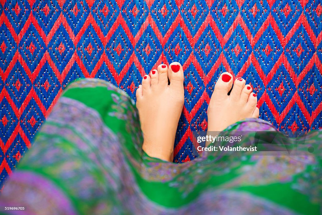 Barefoot woman in a patterned carpet