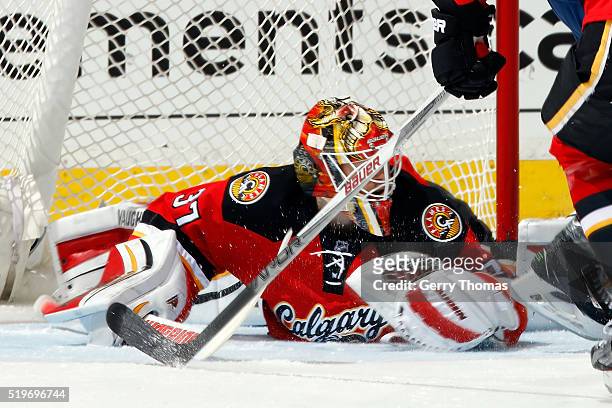 Joni Ortio of the Calgary Flames stretches to make a save against the Vancouver Canucks during an NHL game on April 7, 2016 at the Scotiabank...