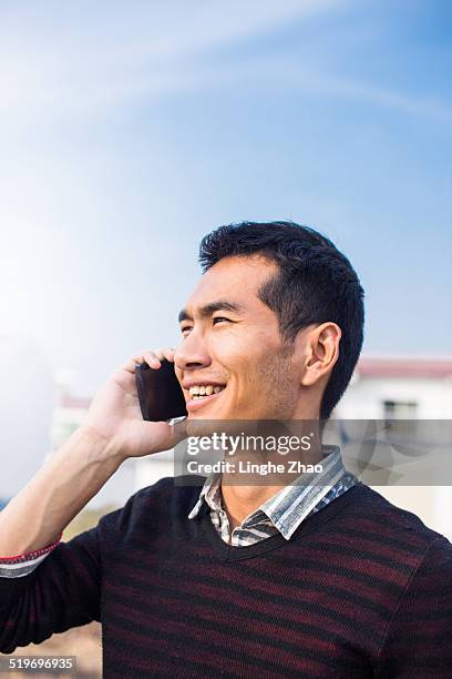 asia man talking with mobile phone - linghe zhao stock pictures, royalty-free photos & images