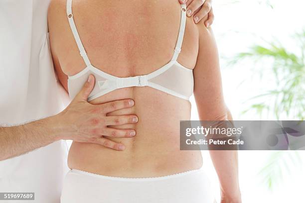 health practitioner giving a woman a treatment . - men wearing bras photos stock pictures, royalty-free photos & images