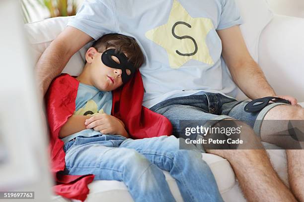 boy dressed up as a superhero fallen asleep. - s thirtysomething stock pictures, royalty-free photos & images