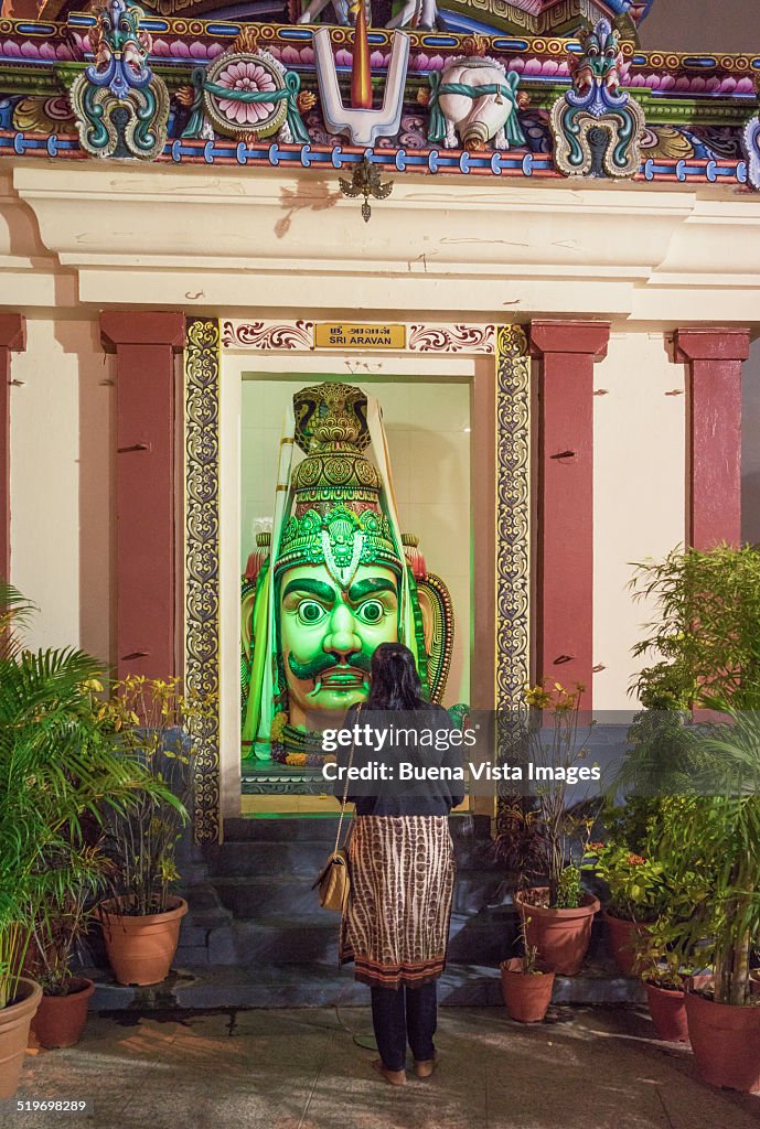 Woman praying a Hindu God