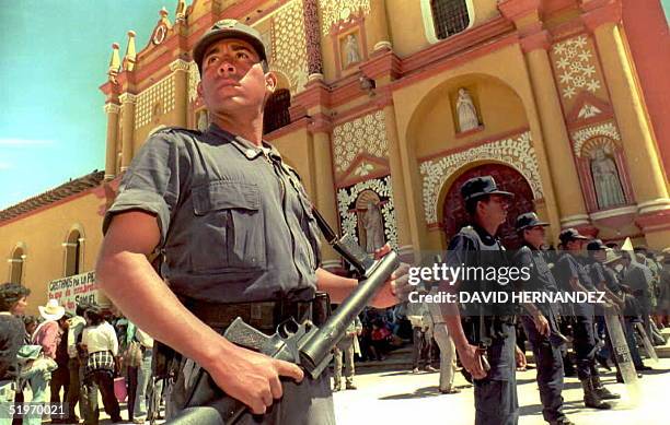 Mexican state and local police stand guard at the San Cristobal de Las Casas cathedral 22 February in the state of Chiapas. Extreme rightist groups...