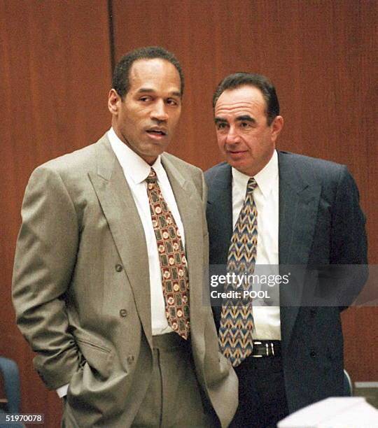 Double murder defendant O.J. Simpson and his attorney Robert Shapiro stand as the jury enters the court during the morning proceedings in his murder...