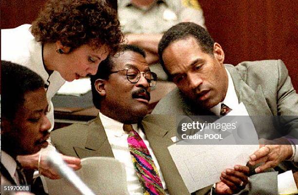 Murder defendant O.J. Simpson , prosecutor Marcia Clark and defense attorney Johnnie Cochran Jr. Look over documents during the afternoon session of...