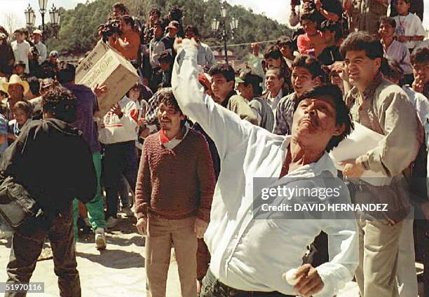 Member of the conservative San Cristobal Civic Front hurls stones at the town's cathedral 19 February while chanting slogans against Zapatista rebels...