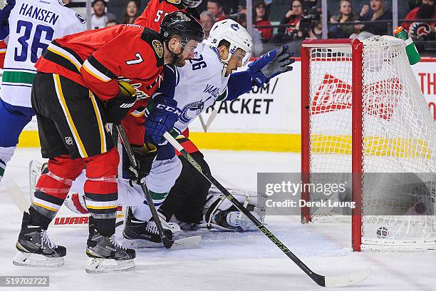 Emerson Etem of the Vancouver Canucks watches his shot fly past Joni Ortio of the Calgary Flames during an NHL game at Scotiabank Saddledome on April...