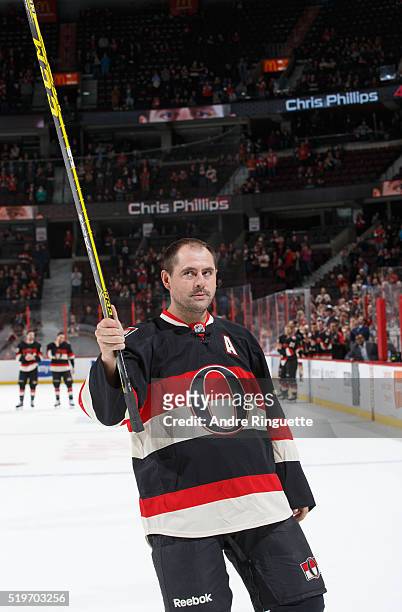 Chris Phillips of the Ottawa Senators raises his stick and salutes the fans after the last home game of the season against the Florida Panthers at...