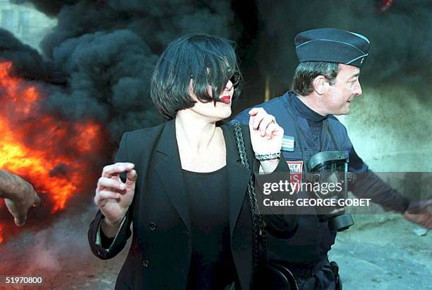 President of the Furiani victims' committee Vanina Guidicelli is taken away by an anti-riot policeman 31 March after the Bastia court, Corsica ,...