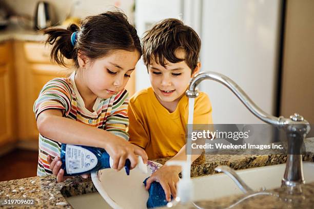 home fun for kids - wash the dishes stock pictures, royalty-free photos & images