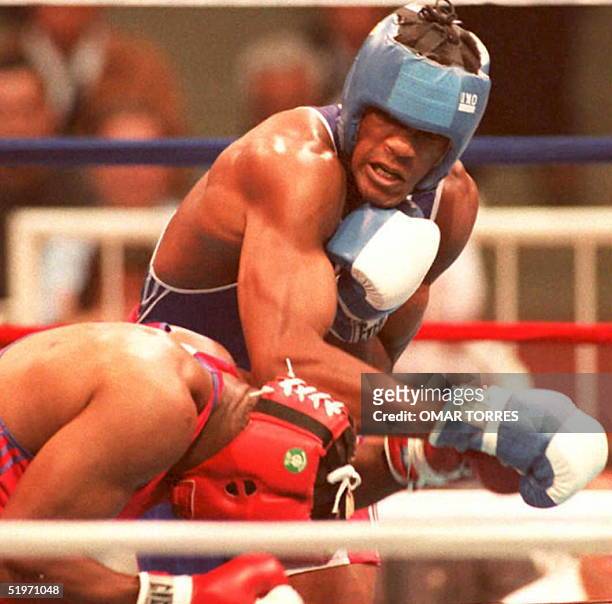 Cuban boxer Felix Savon punches US boxer Lamon Brewster 25 March during their heavyweight gold medal bout at the Pan American Games in Mar del Plata,...