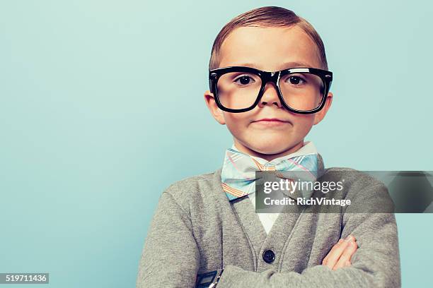 young nerd boy folding arms and blank expression - nerd sweater stock pictures, royalty-free photos & images