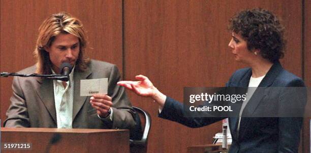 Prosector Marcia Clark shows O.J. Simpson house guest, Brian "Kato" Kaelin a picture of the the crime scene at the O.J. Simpson estate 21 March 1995...