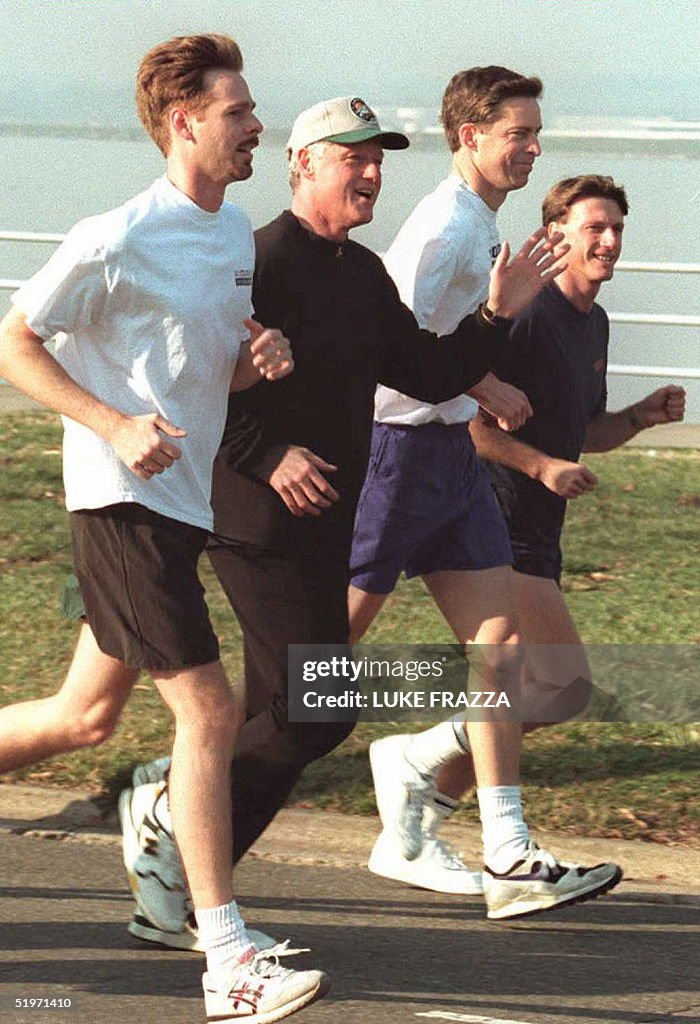 US President Bill Clinton (2nd-L) jogs with Mark M