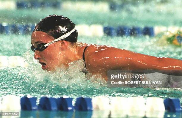 Amy Van Dyken of the US churns through the water during the women's 100 butterfly swimming competition 15 March at the Pan American Games in Mar del...