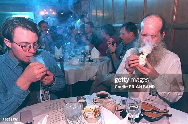 Eric Anderson and John Causgrove , both employees of the Chicago's Up Down Tobacco Shop, light their pipes at the 15th Annual Chicago Pipe Smoking...