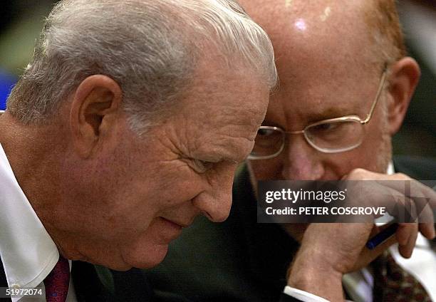 Former US secretary of State James Baker , advisor for Republican presidential candidate George W. Bush, confers with lawyer Ben Ginsberg during...